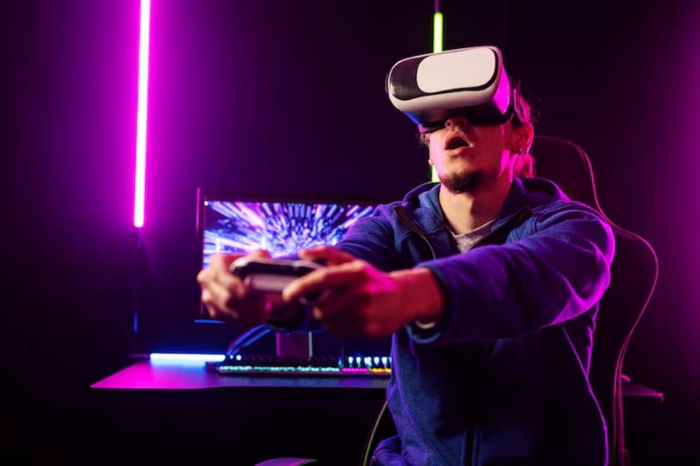 A person wearing a VR headset holds a gaming controller, immersed in a colorful gaming setup with neon lighting and a vivid screen display.
