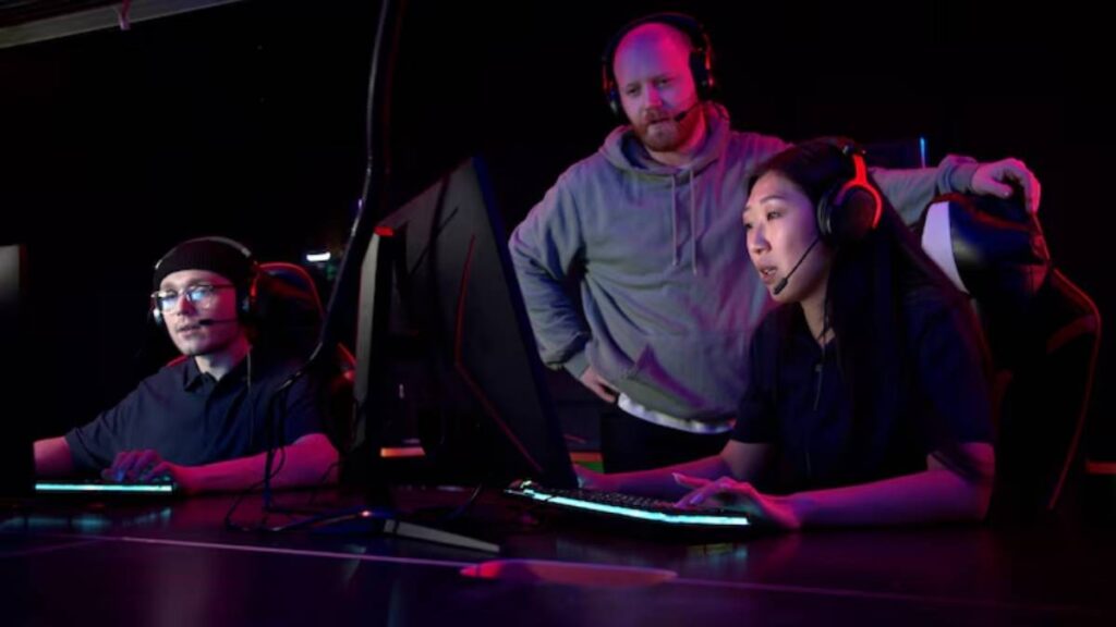 Two gamers are engaged in a gaming session at a sleek and their coach is stand nearby.