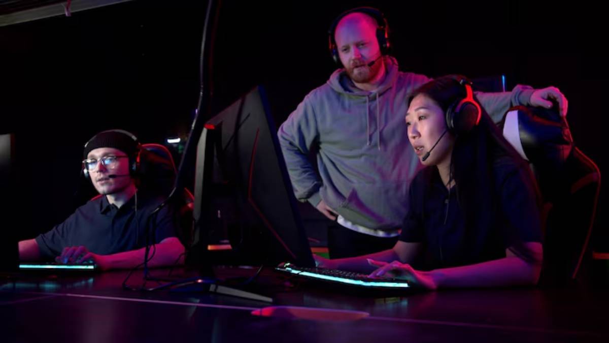Two gamers are engaged in a gaming session at a sleek and their coach is stand nearby.