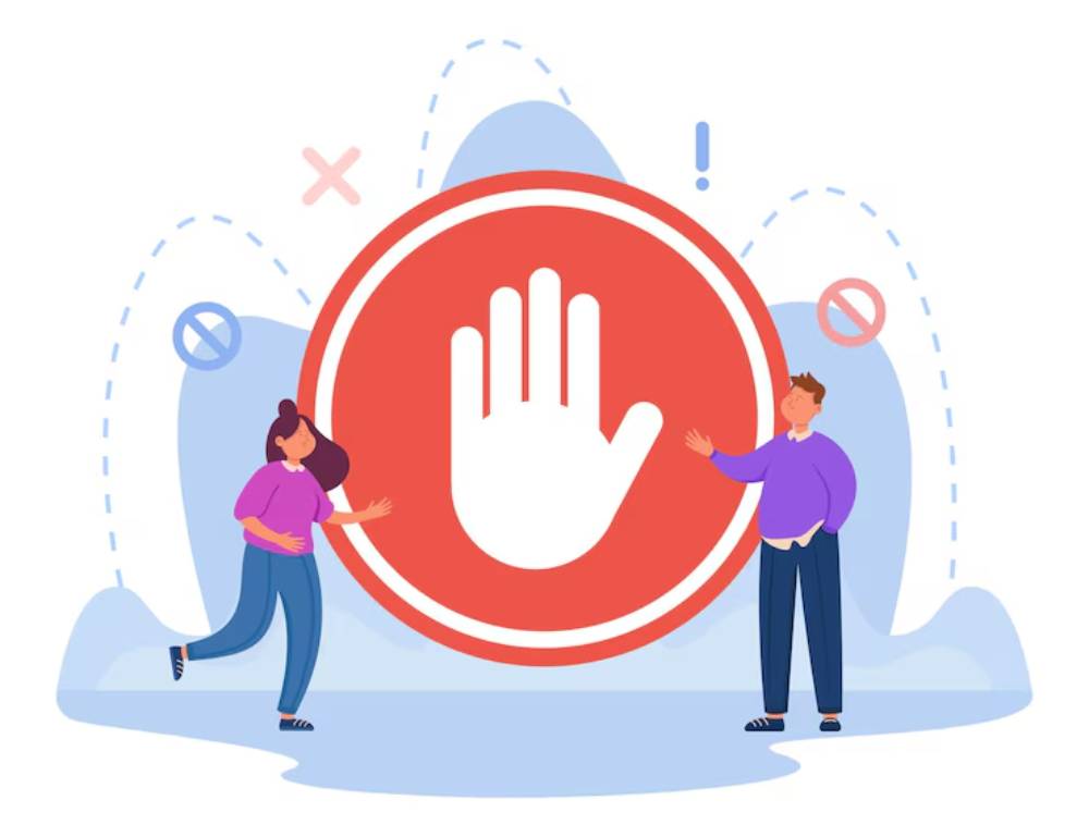 A woman and a man stand beside a large red stop hand symbol, indicating a message of caution or refusal.