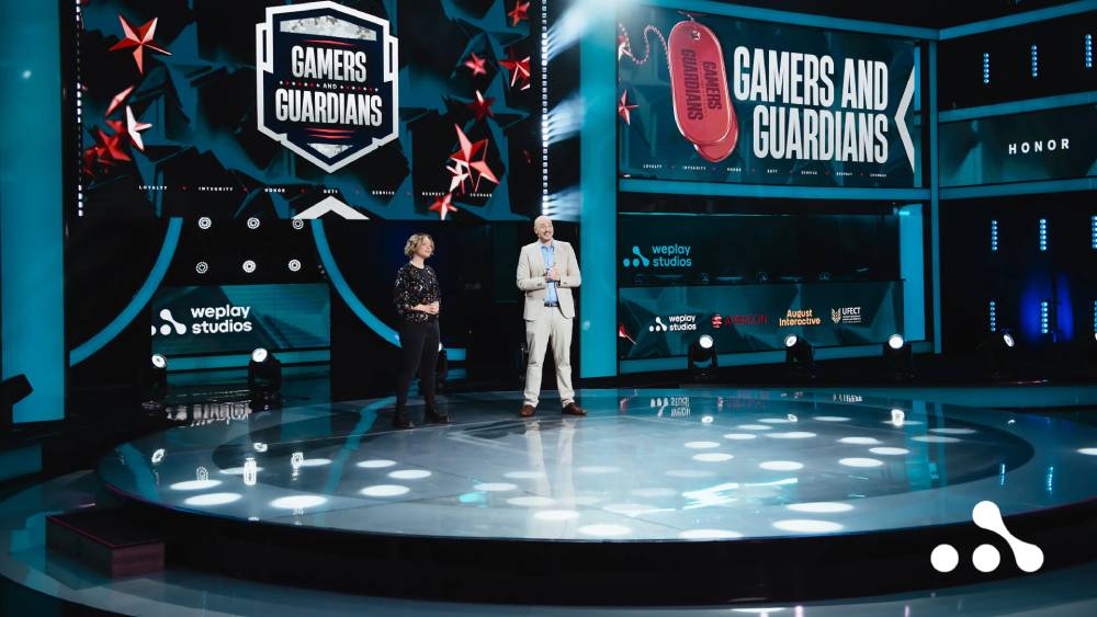 A stage presentation featuring two speakers at the