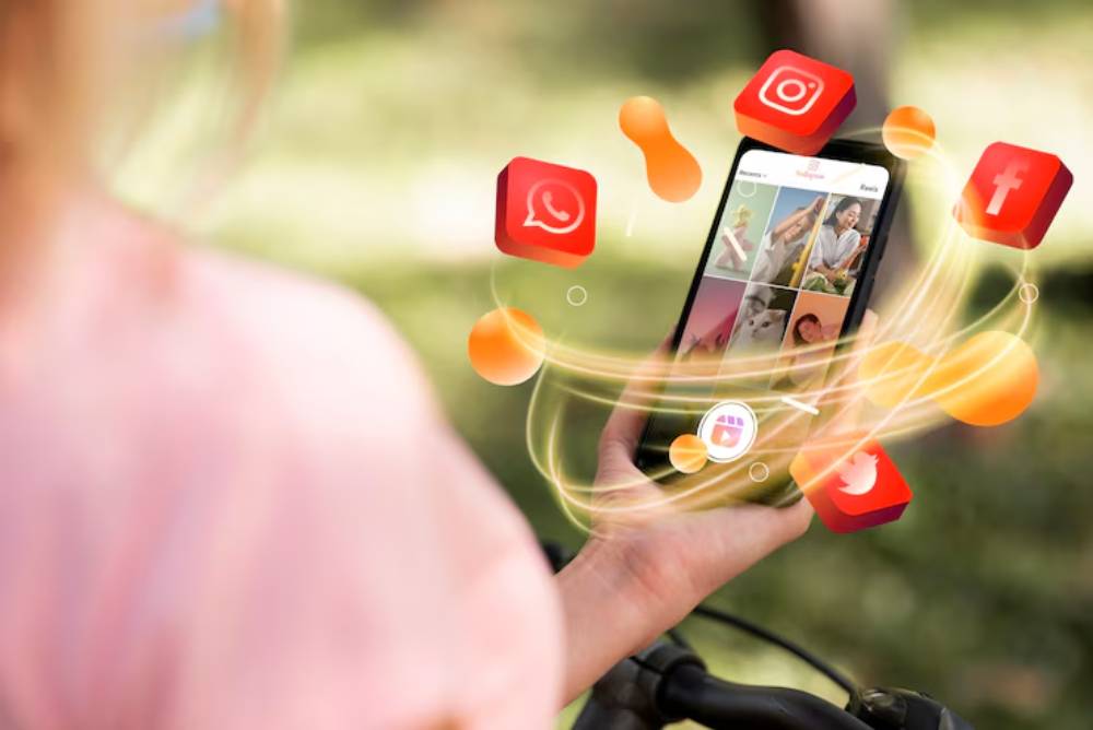 A person holds a smartphone displaying reels, surrounded by floating social media icons like Instagram, Facebook, and Twitter.
